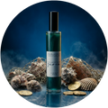 A bottle of mawamo Siren body oil with a black cap and white label with blue metallic foil writing, surrounded by a fishnet, gold coins, sea shells and ocean mist.